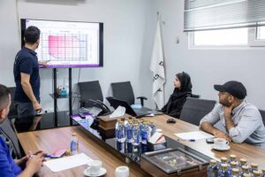 Interns analyzing pressure chart at Dana Energy